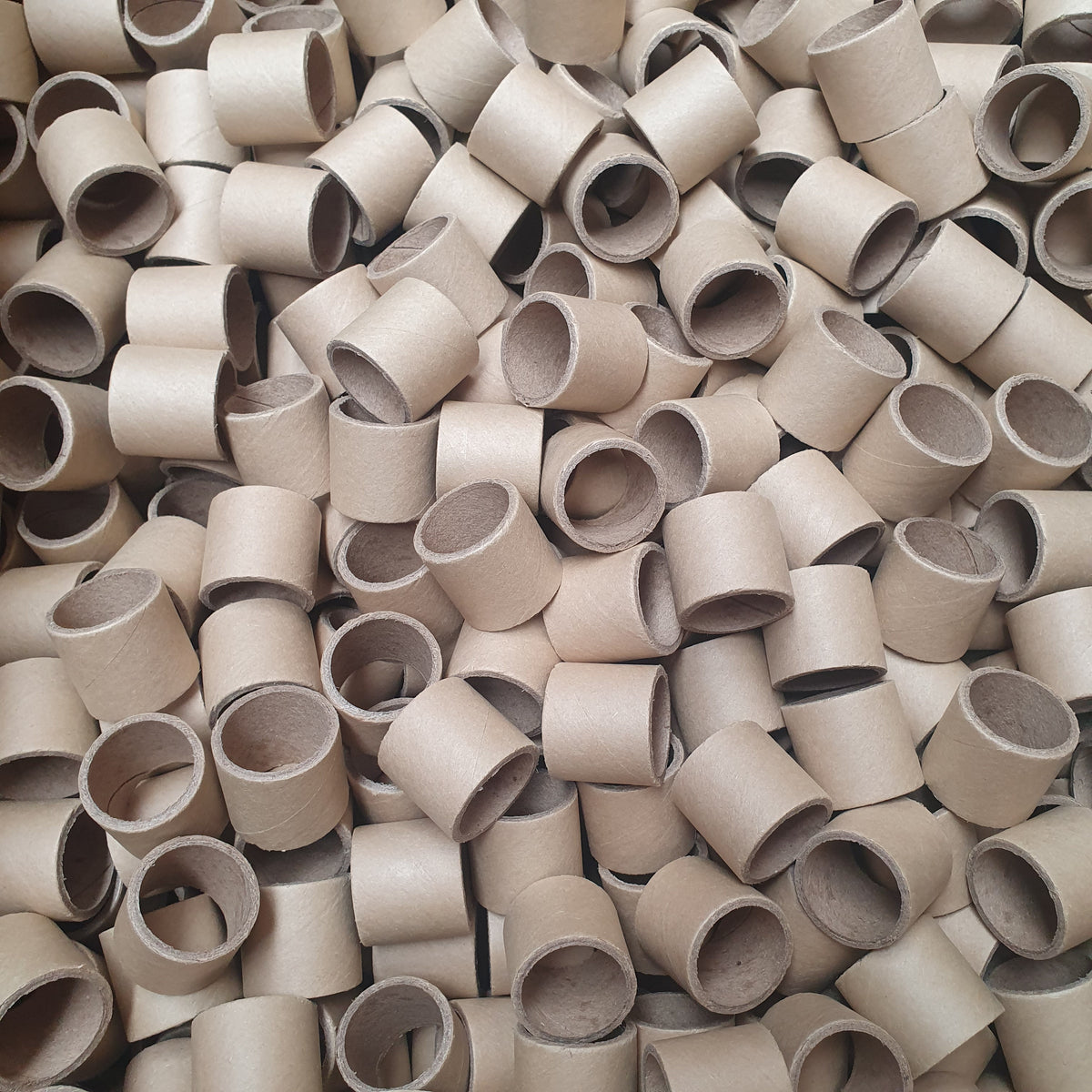 Large pile of beige plastic pipe fittings.
