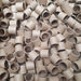 Large pile of beige plastic pipe fittings.