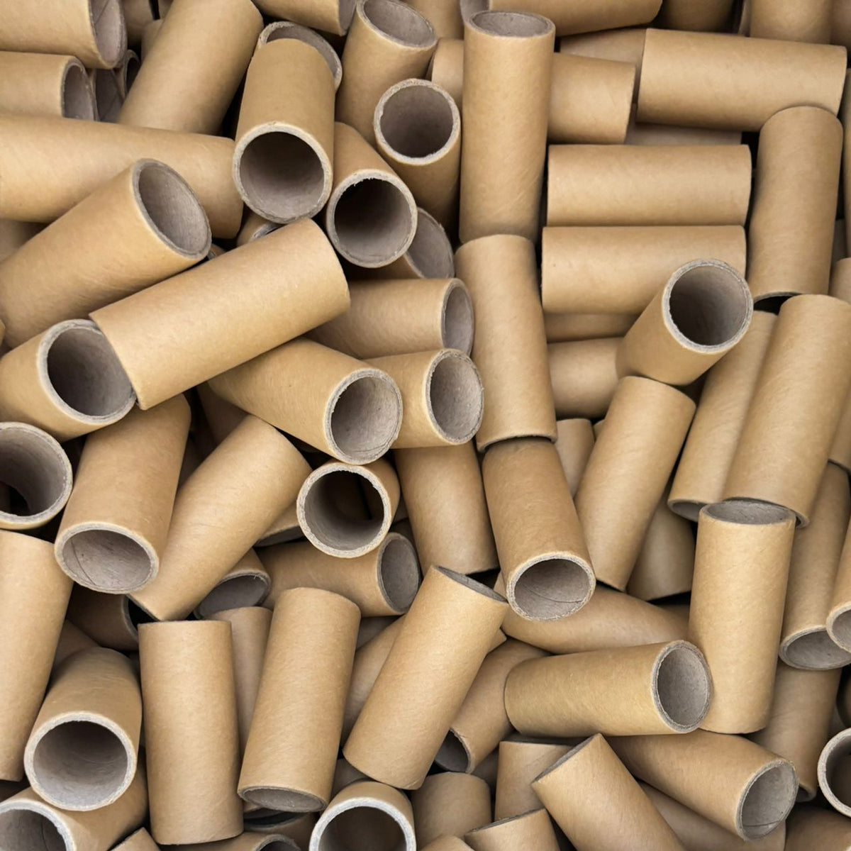 Large pile of cardboard tubes
